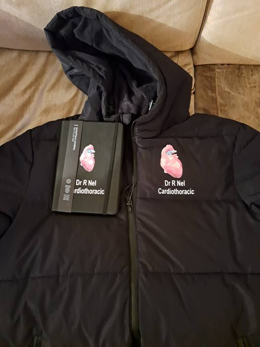 Black hooded puffer jacket and matching notebook printed with an anatomical heart and Dr R Nel Cardiothoracic
