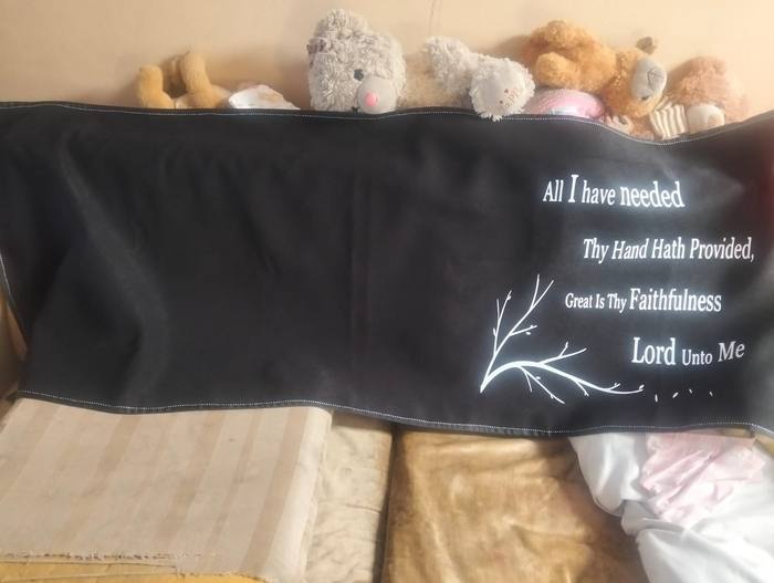 Black fleece blanket printed with the hymn line Great Is Thy Faithfulness beside a bare branch
