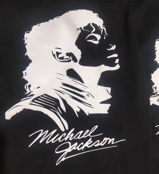 Black t-shirt printed with a white portrait of Michael Jackson above his signature